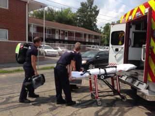 EMTs loading ambulance with equipment