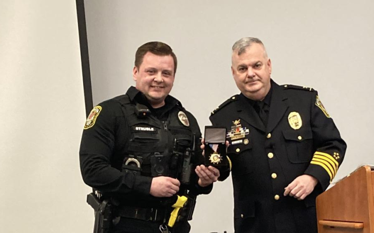 Officer Struble receiving the Medal of Valor from Chief Jones 