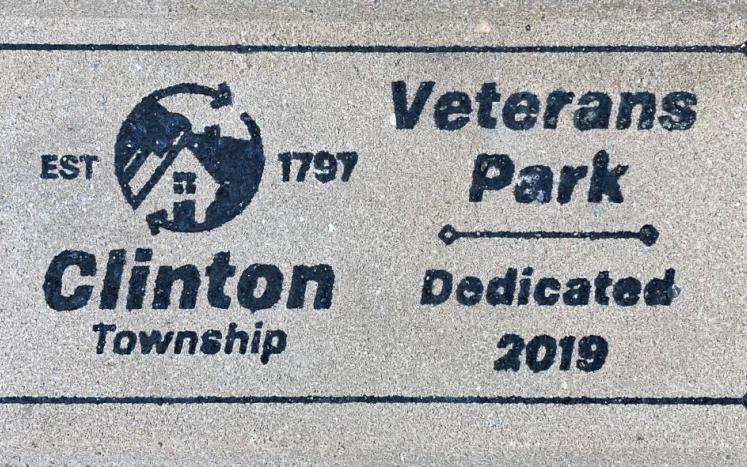 Brick paver with text, "Clinton Township established 1797" on the left and "Veterans Park, dedicated 2019" on the right.
